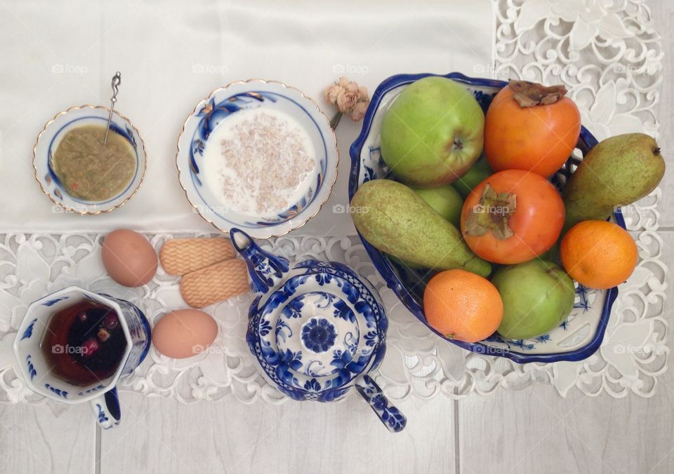 Food on white napkin: fruits , tea , cookies, cereals 