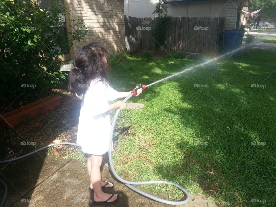 Spraying water.. little girl spraying water.