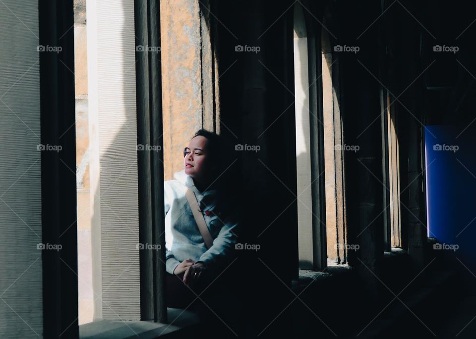 Gorgeous woman staring from multiple windows of Durham Cathedral