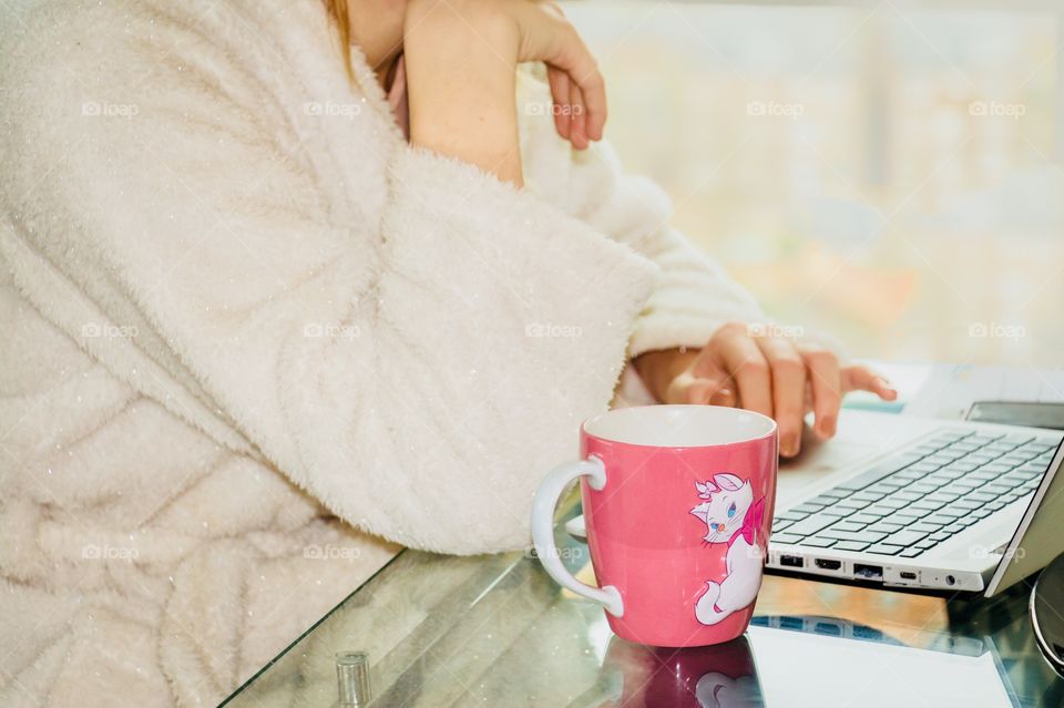 Girl have a coffee and surfing in the net