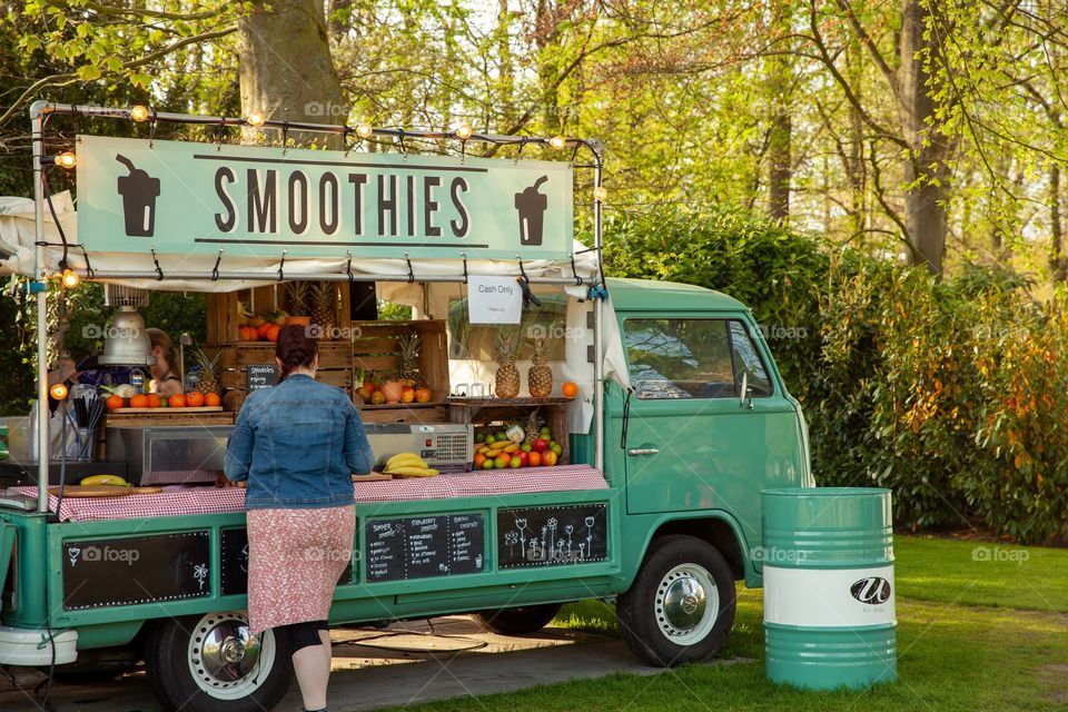 Woman is standing at the Street food car 