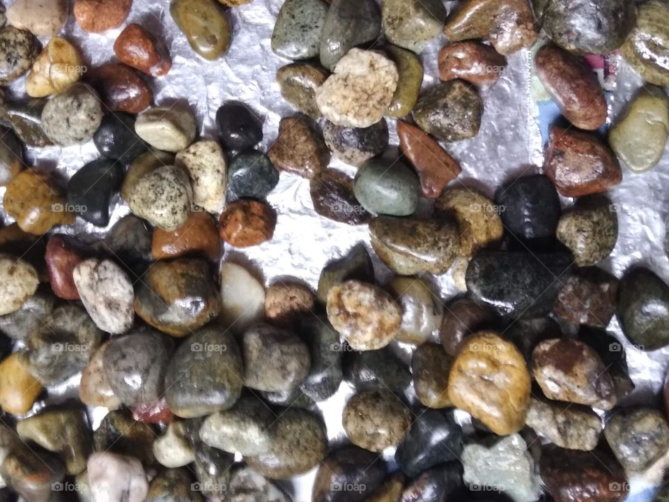 River rocks creating a stunning array of colors, like pieces to a jigsaw puzzle.