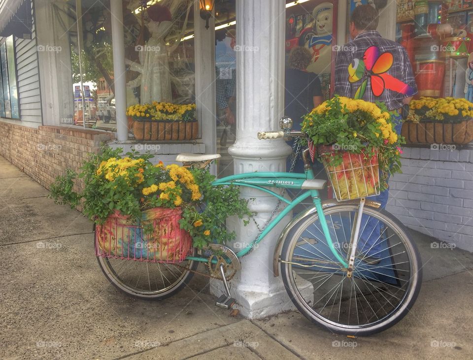 Antique vintage bicycle in front of store with flowers