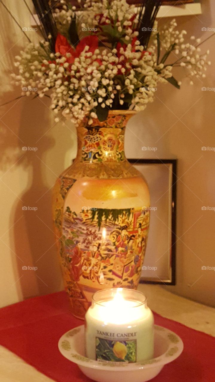 intimate corner of floral vase and candle