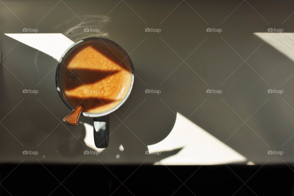 Cup of coffee with triangular shadows