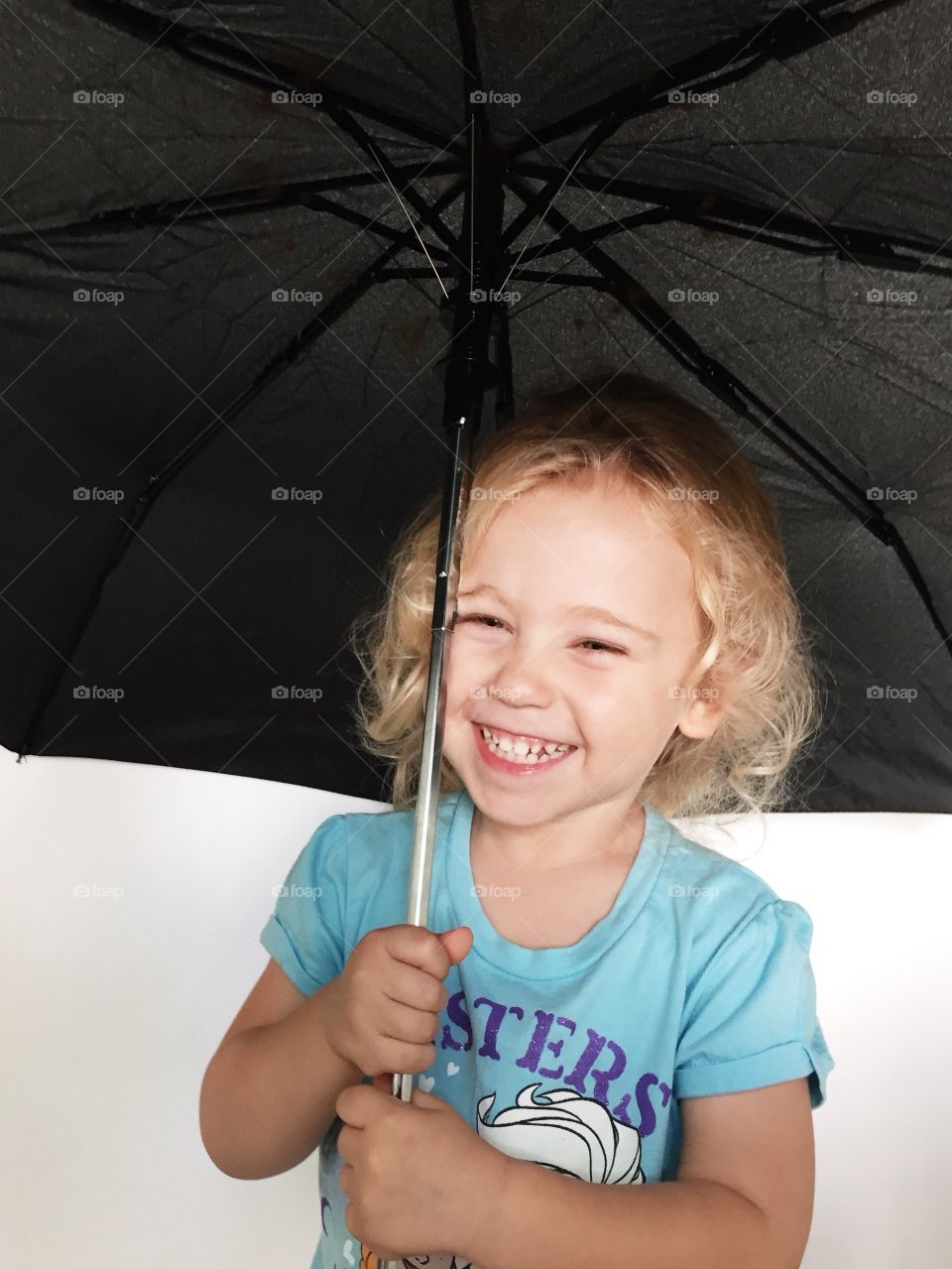 Portrait of cute girl holding an umbrella