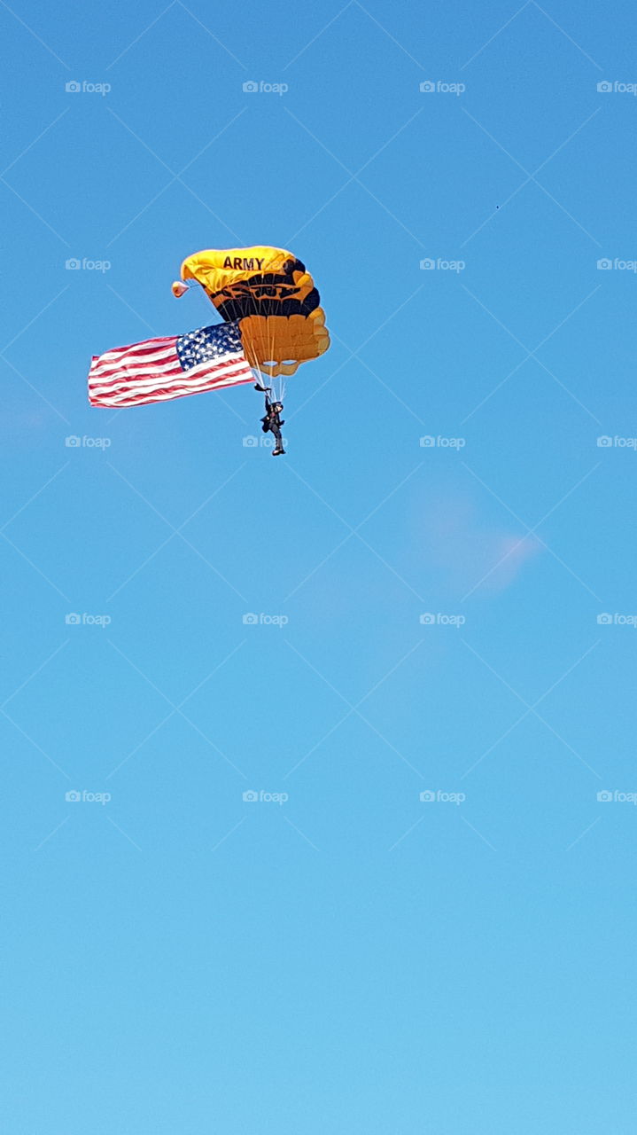 US Army Golden Knights parachuting with American Flag