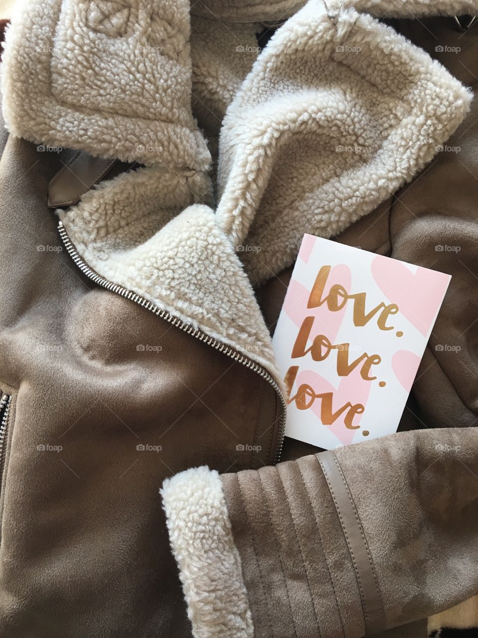 Flat lay items. card with inscription love lying on coat