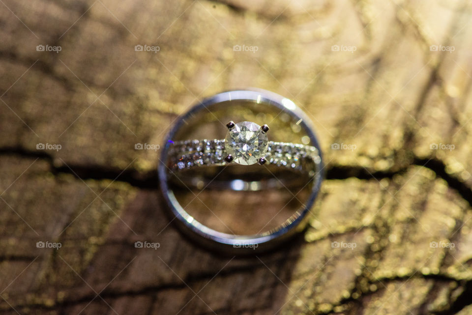 Brides wedding ring in grooms ring arial view