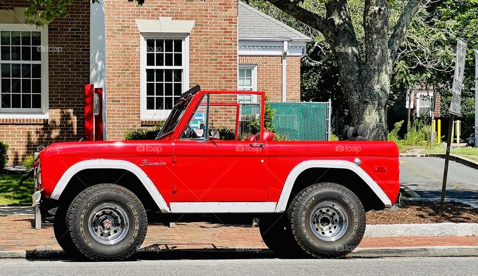 Red Ford Bronco 4x4 . It’s said to be good on pavement and off the road. Pleasing to look at. 