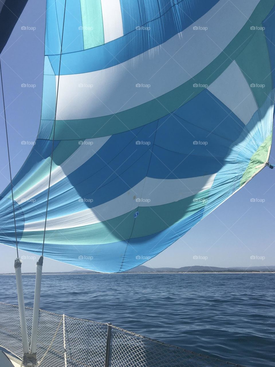 Blue spinnaker on blue sea