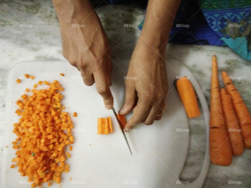 Handy women slice carrots