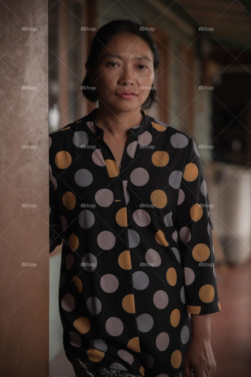 Portrait shot of woman wearing polka dots top.