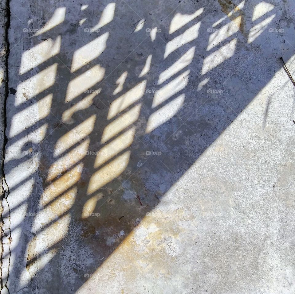 Shadows through lattice on a bright afternoon.