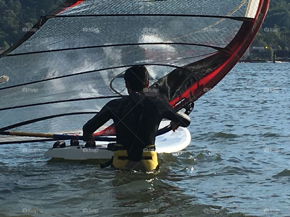 Man windsurfer in water