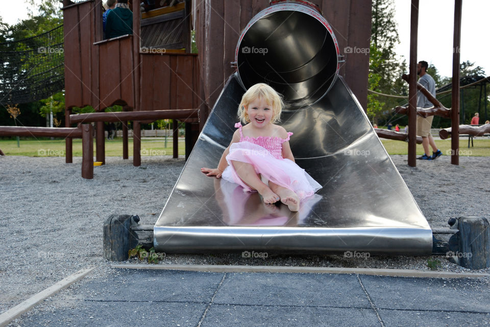 little girl of two years old on the ski slide at Knutenborg Zoo in Denmark.