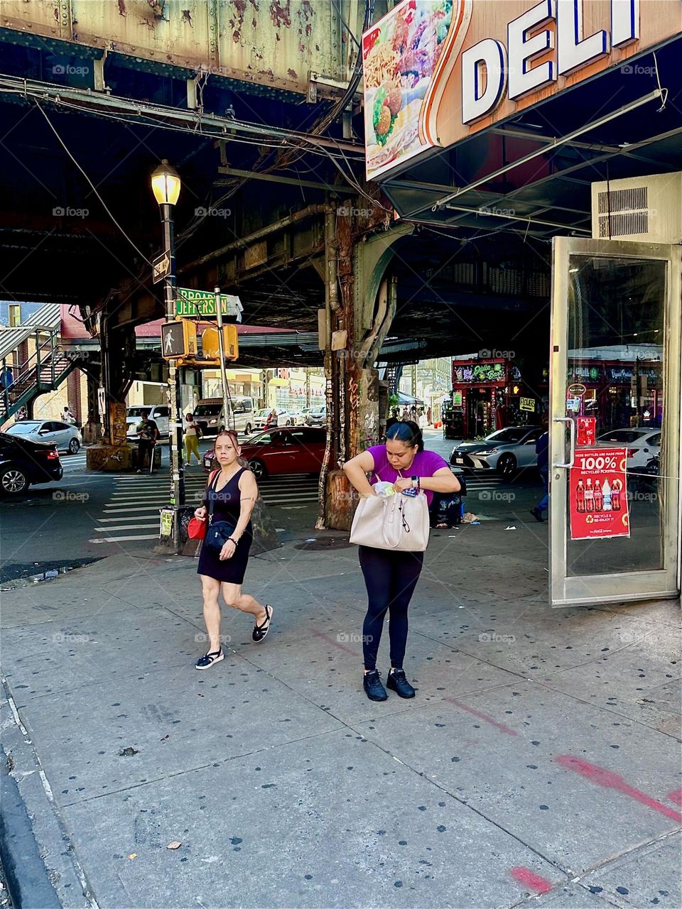 At the intersection of “Jefferson St”, “B’way” and “Myrtle Ave” at the “Myrtle Ave” “M” train station in “Bushwick”, Bklyn a woman frantically searches her large purse. I sincerely hope she finds what she is looking for. 2024. Hypnotic Productions