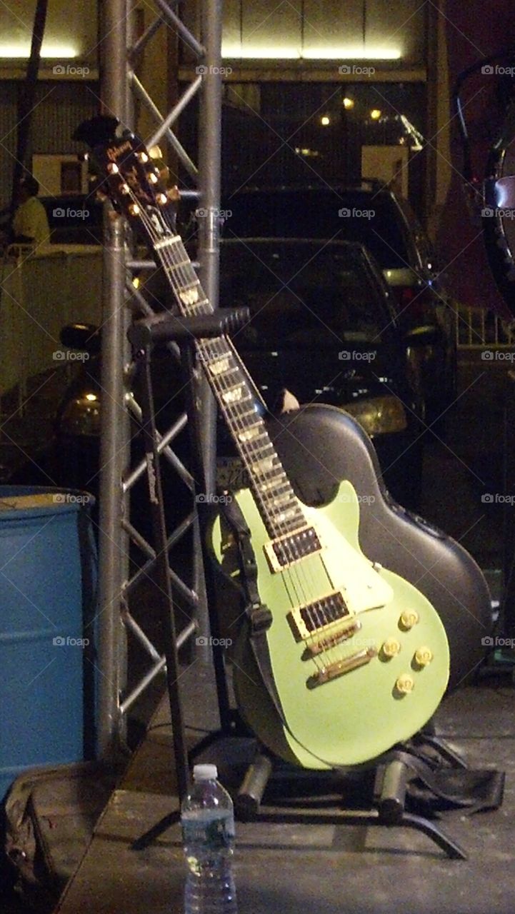Irishman's Guitar. watching a local Celtic rock band play I see a very cool looking green Gibson Les Paul electric guitar .