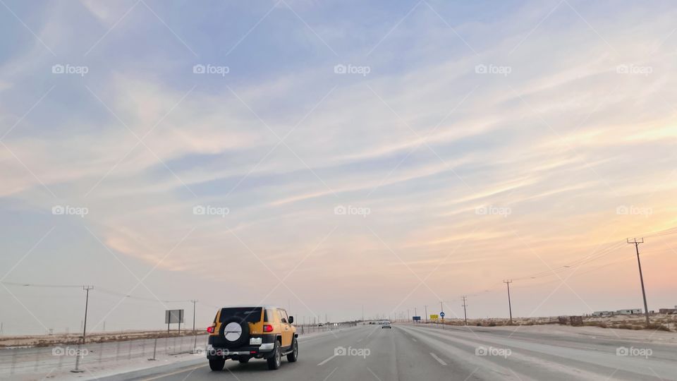 Car on the road and beautiful sky