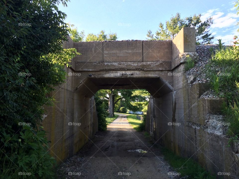 Old railroad overpass over long driveway