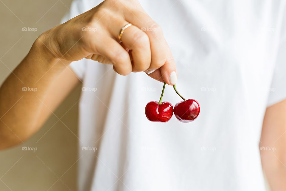 Woman hand holding fresh cherries 