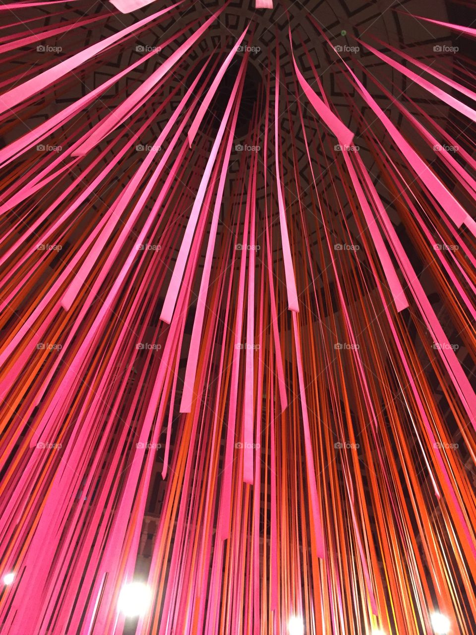 Pink streamers hanging from the ceiling. 