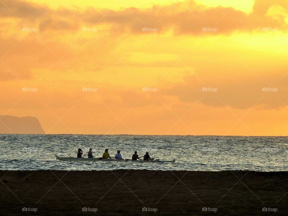 Paddling before the sunsets over Kauai Island