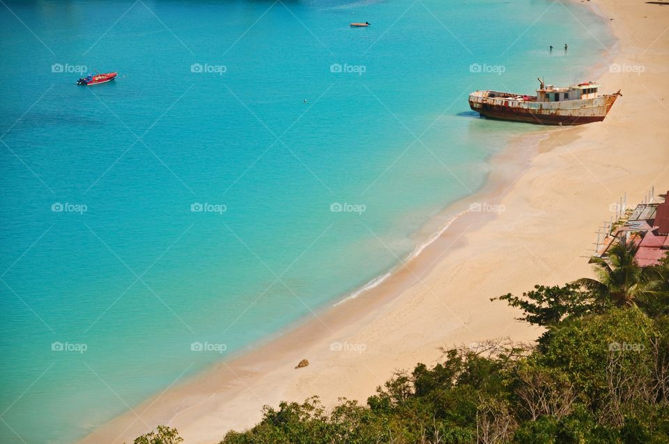 Beach with wrecked boat on it