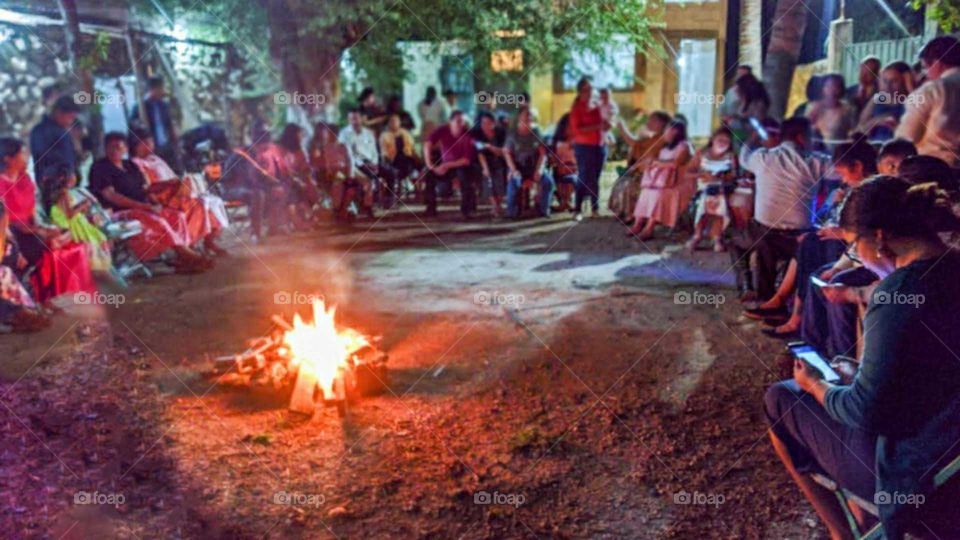 families together enjoying the campfire