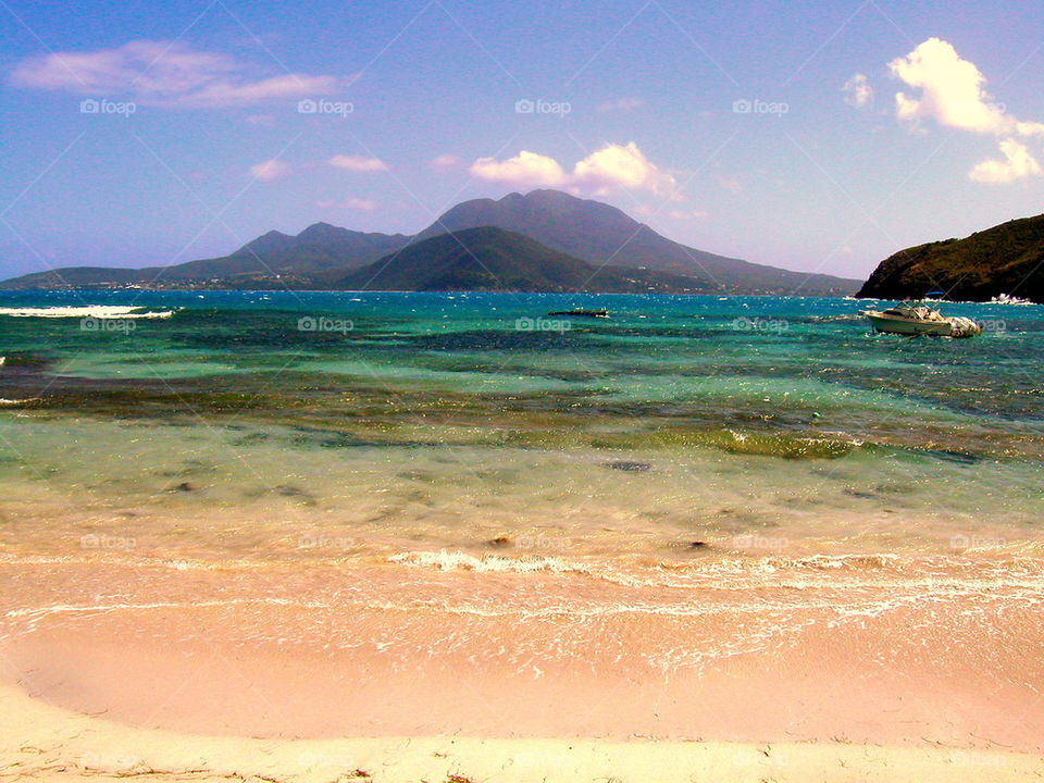 Nevis Across the Pond. Sitting on monkey beach. The Twin Peaks of Nevis in the background. The channel is only 6 miles wide.