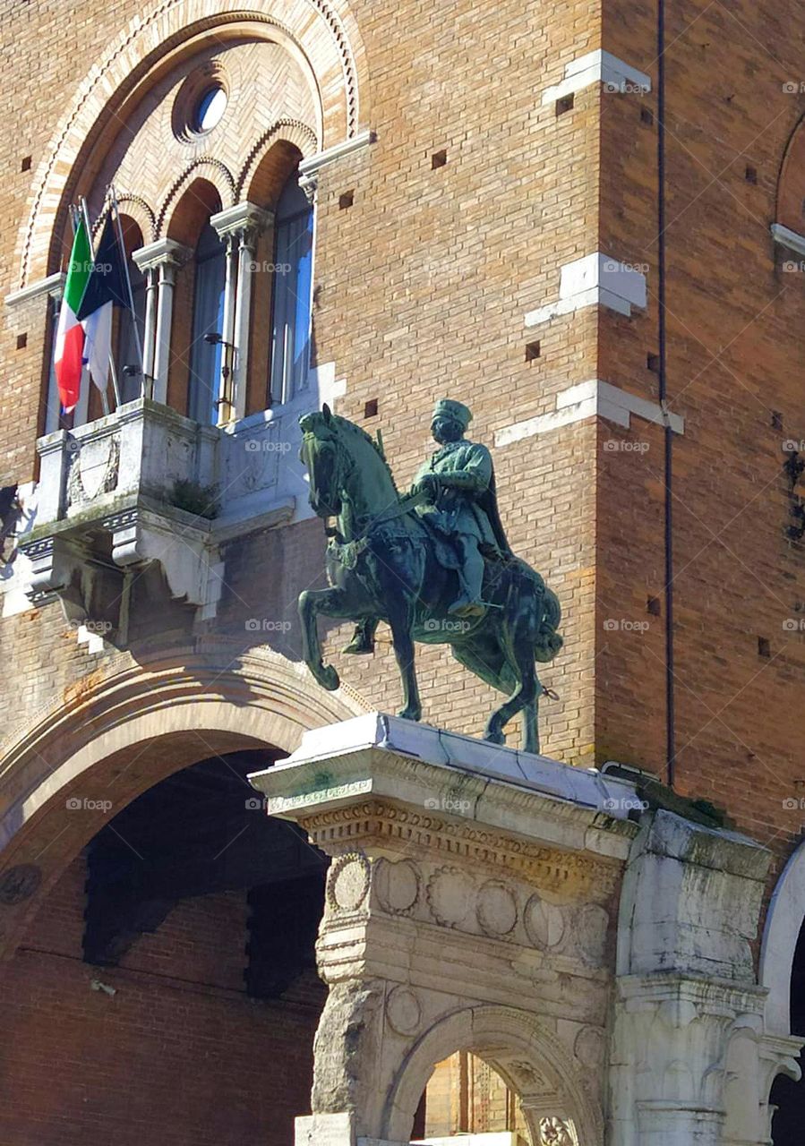 Metal. Italy. City of Ferrara: Palazzo Ducale and Camerino delle Duchess. On one side of the entrance to the palace is a metal statue of the Marquise Niccolò III on horseback.