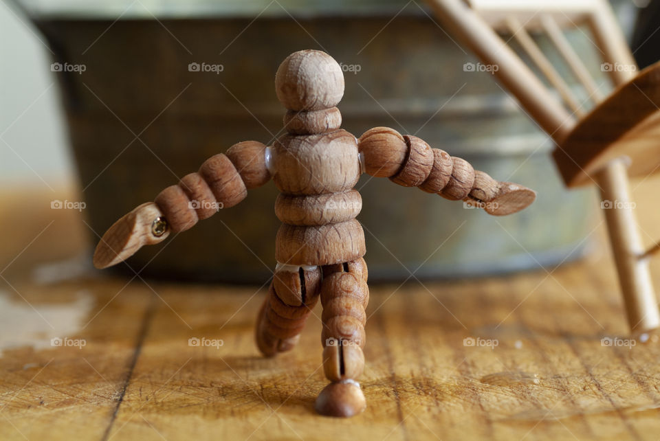 A wooden man performs a dance of joy.