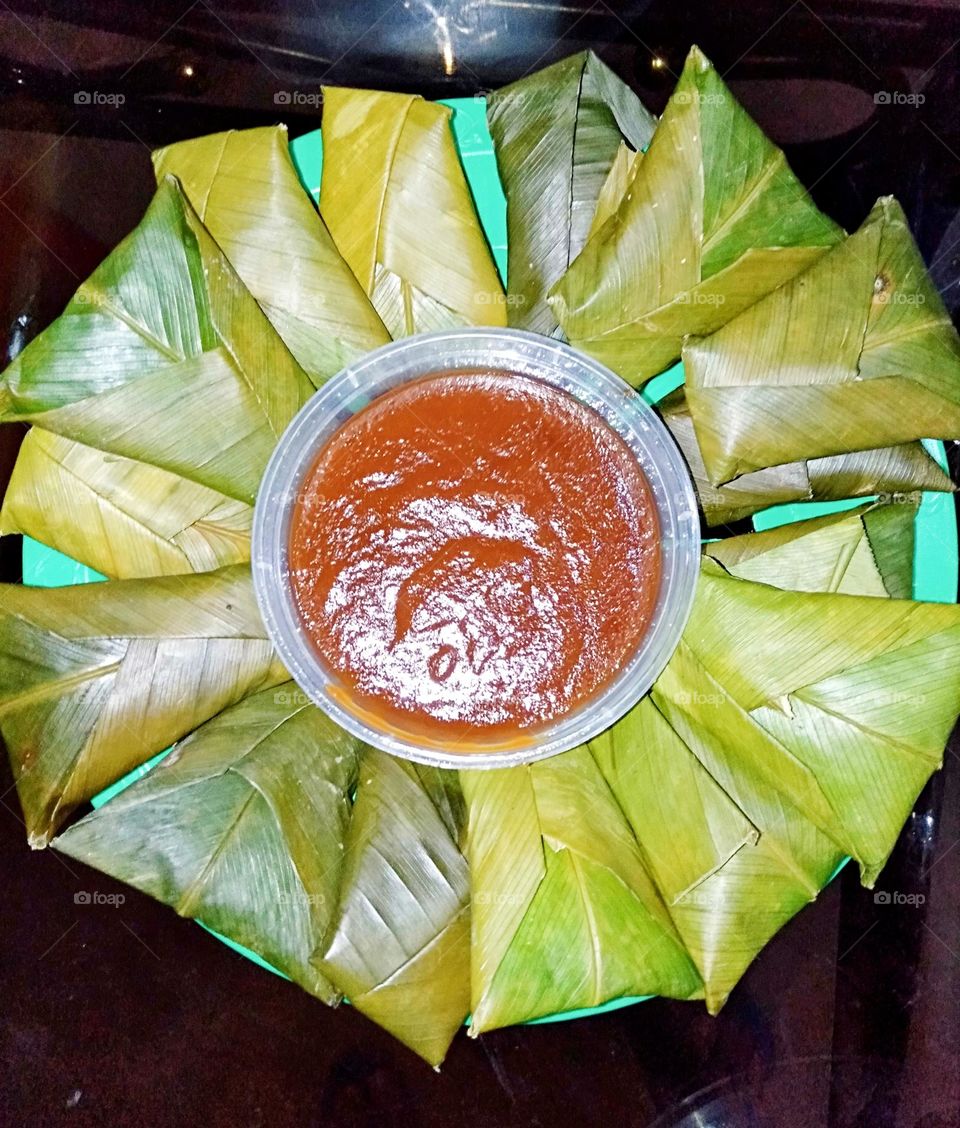 Suman latik a Glutinous rice cake wrapped in banana leaves with coconut caramel sauce.