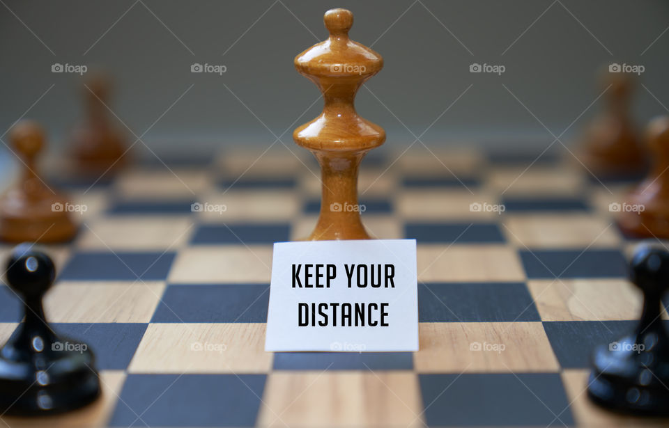 Chess piece expressing keep your distance with sign