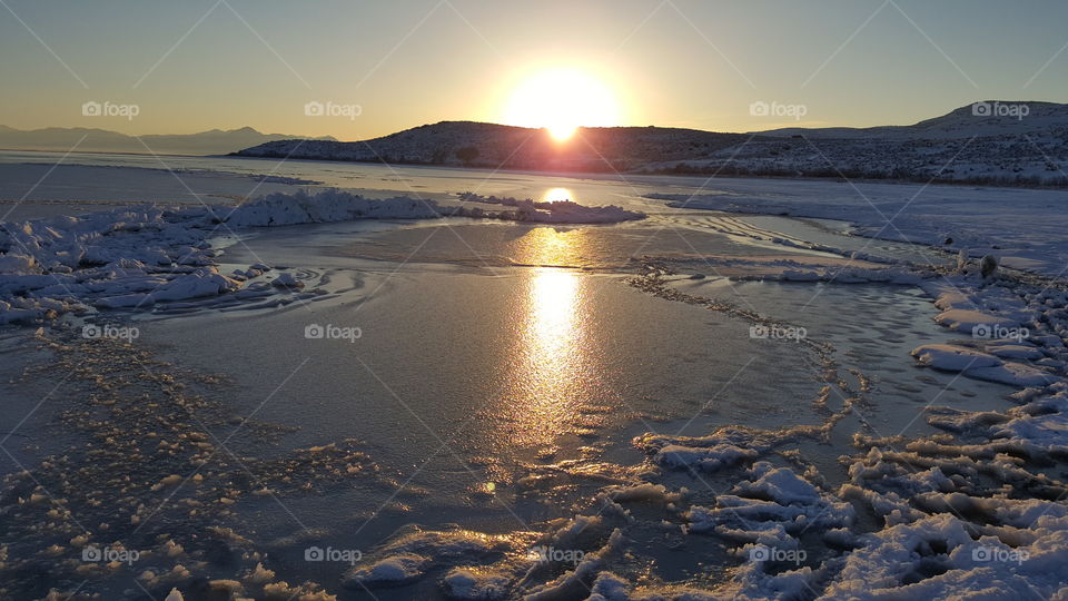 Frozen Utah Lake at sunset