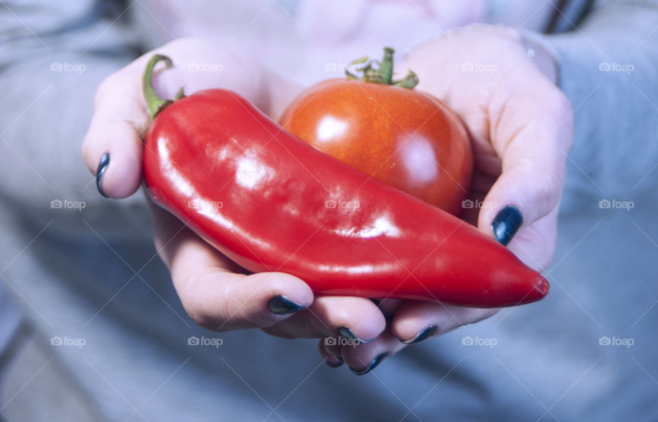 The girl is holding vegetables