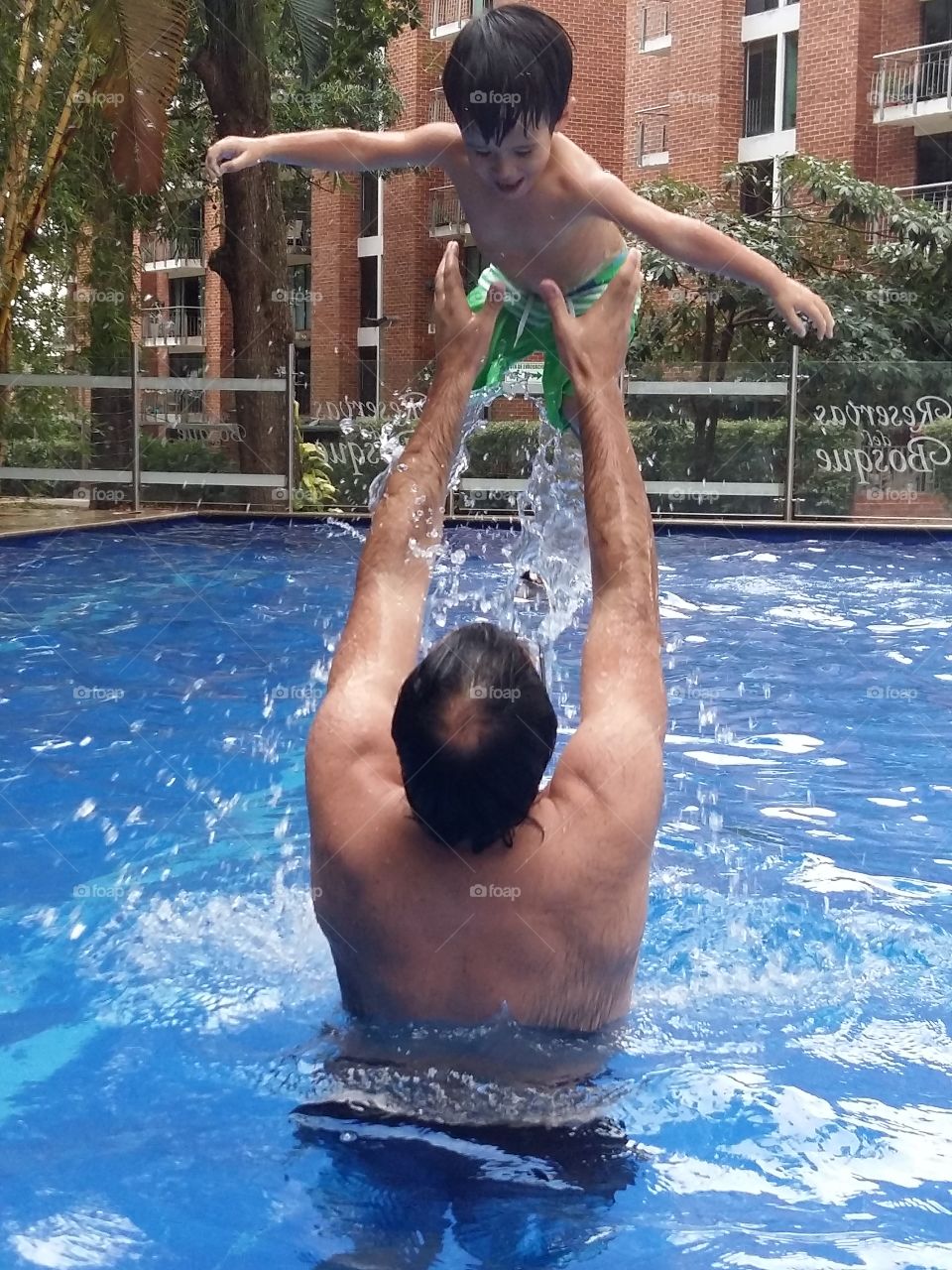 Father and son summer fun at the pool