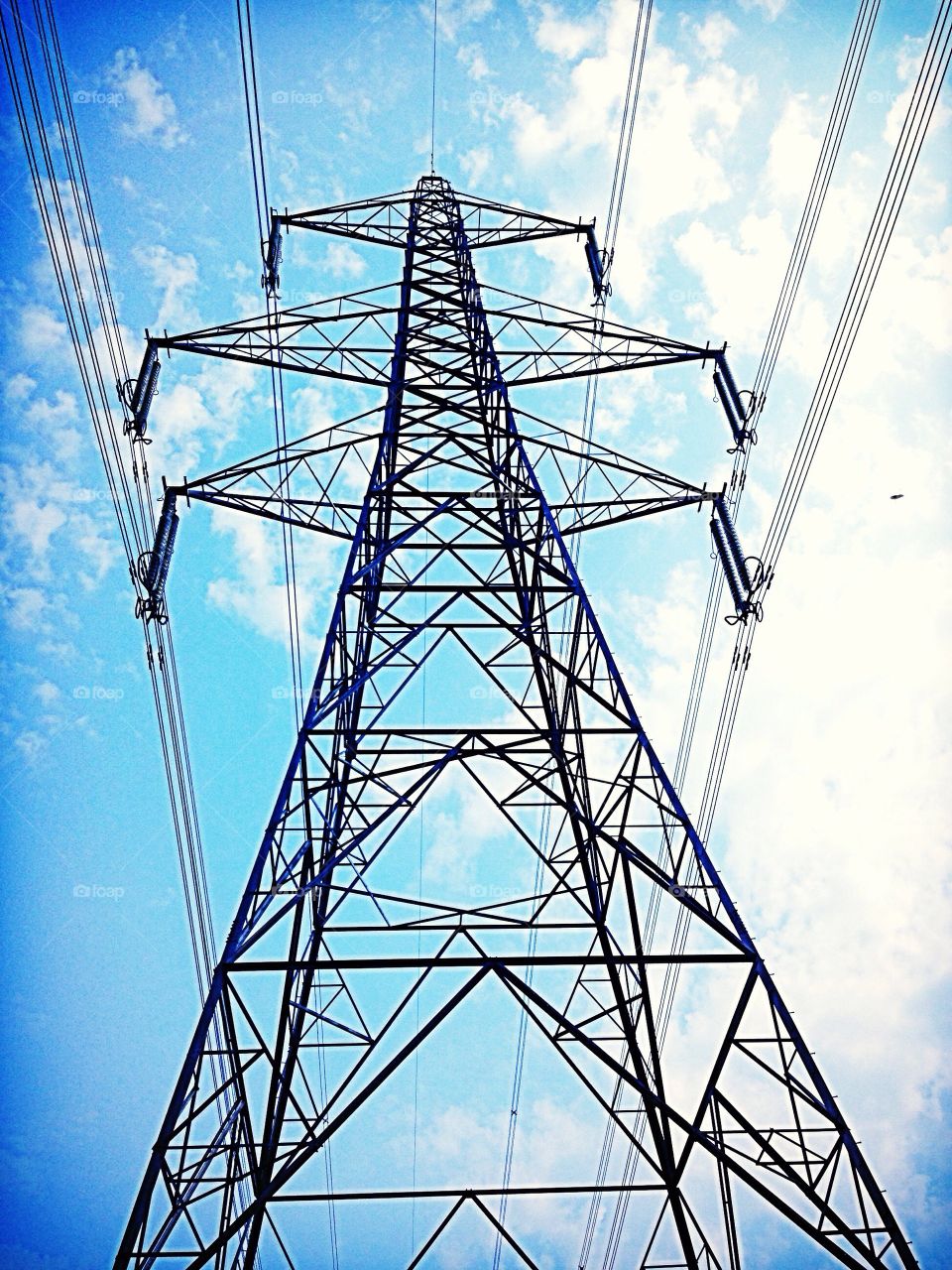 Directly below electricity pylon 