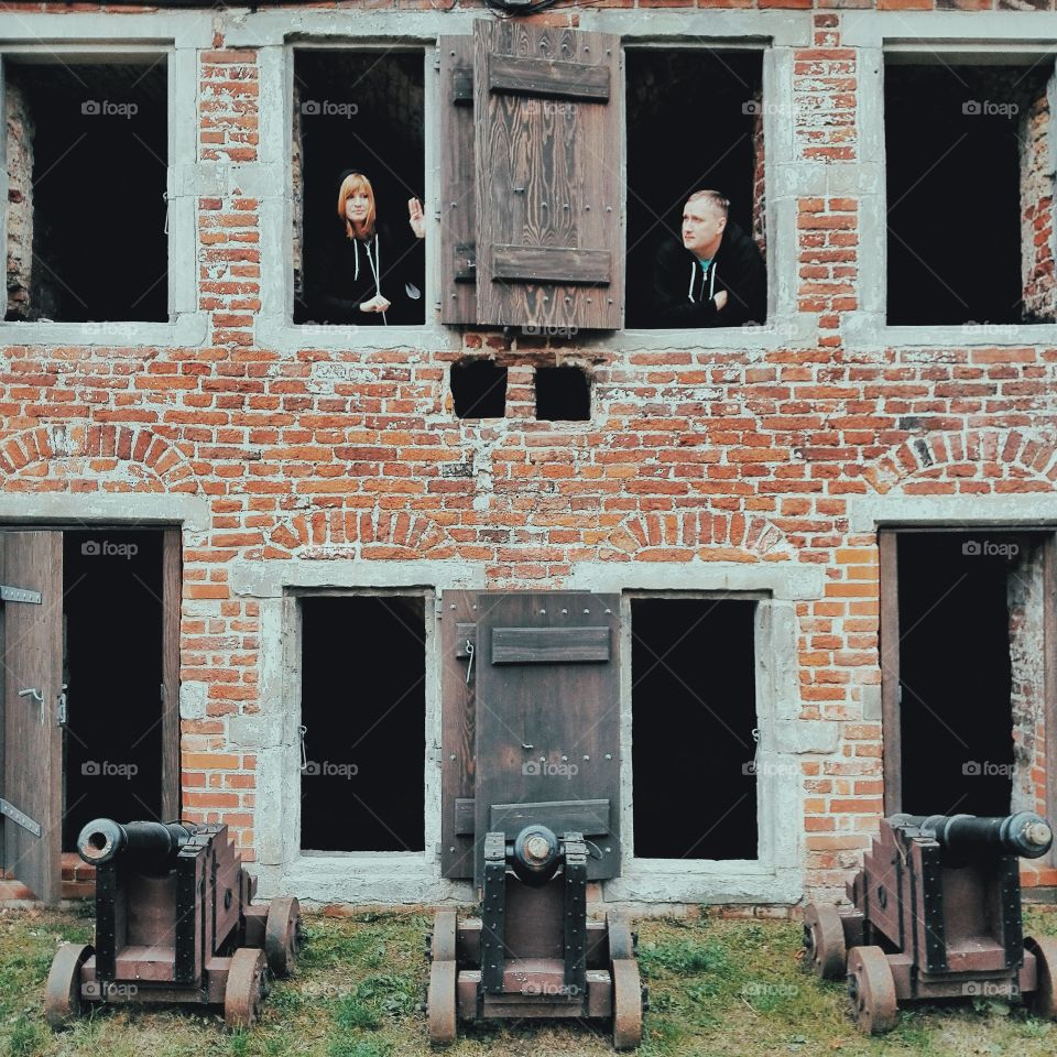 Man and woman standing in window