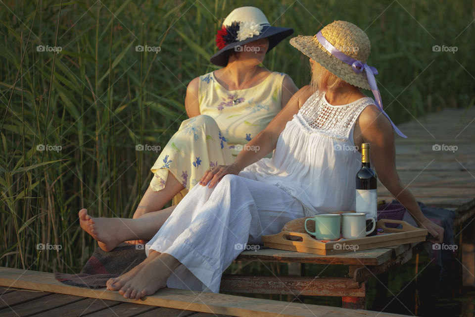 girlfriends on a picnic by the lake, summer