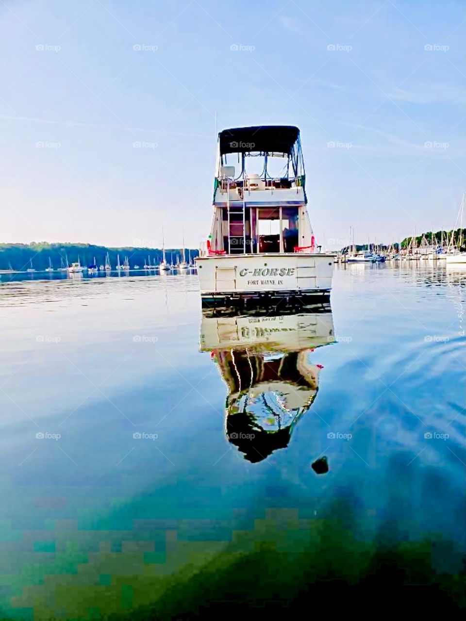 A beautiful pattern made by the water of the East River at Newtown Creek in Long Island City, Queens, NY as a boat drives through it with a stacked fly bridge on a clear bright sunny afternoon in the summer of 2021. Hypnotic Productions