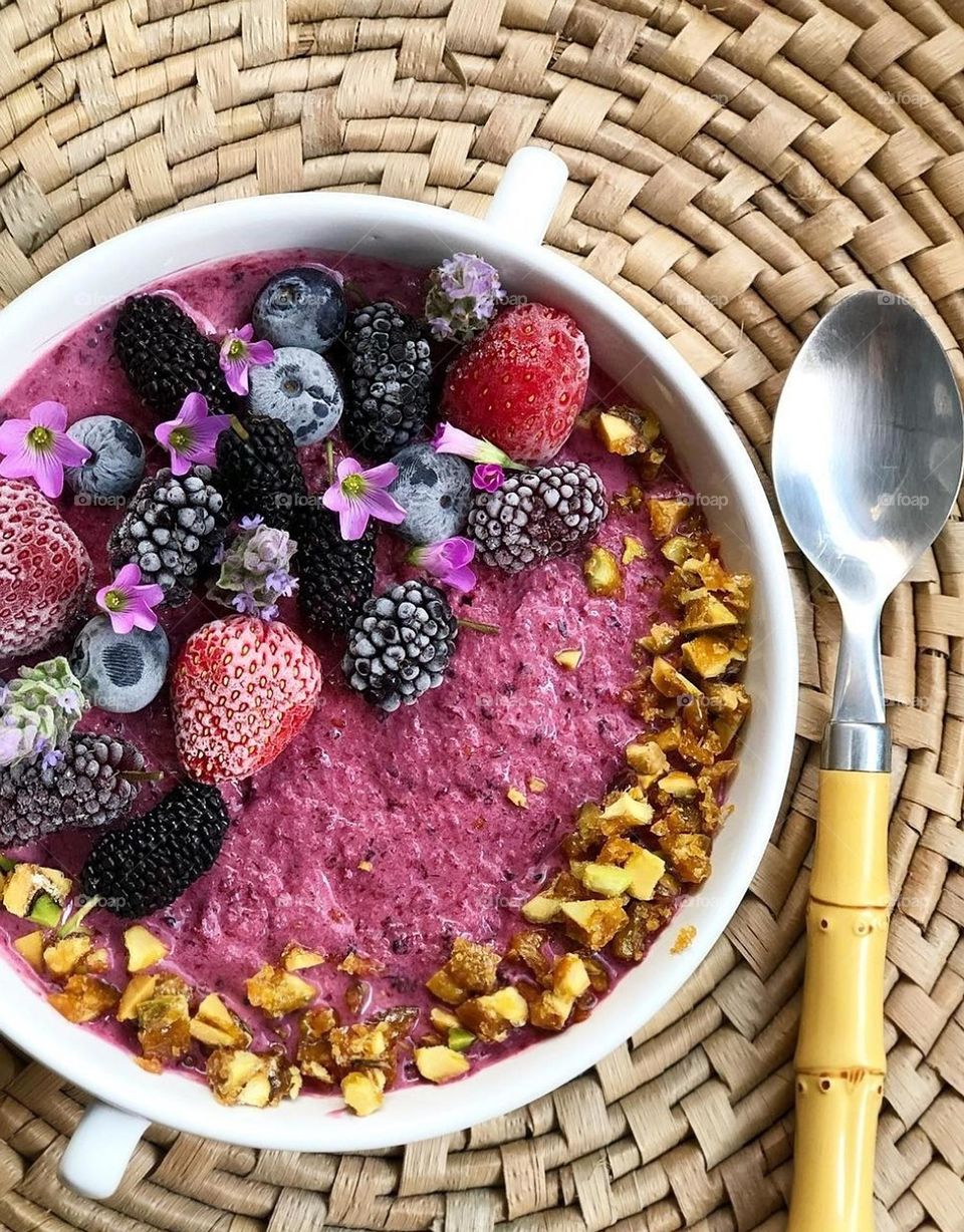 Breakfast with yogurt, blueberries, strawberries and cereal