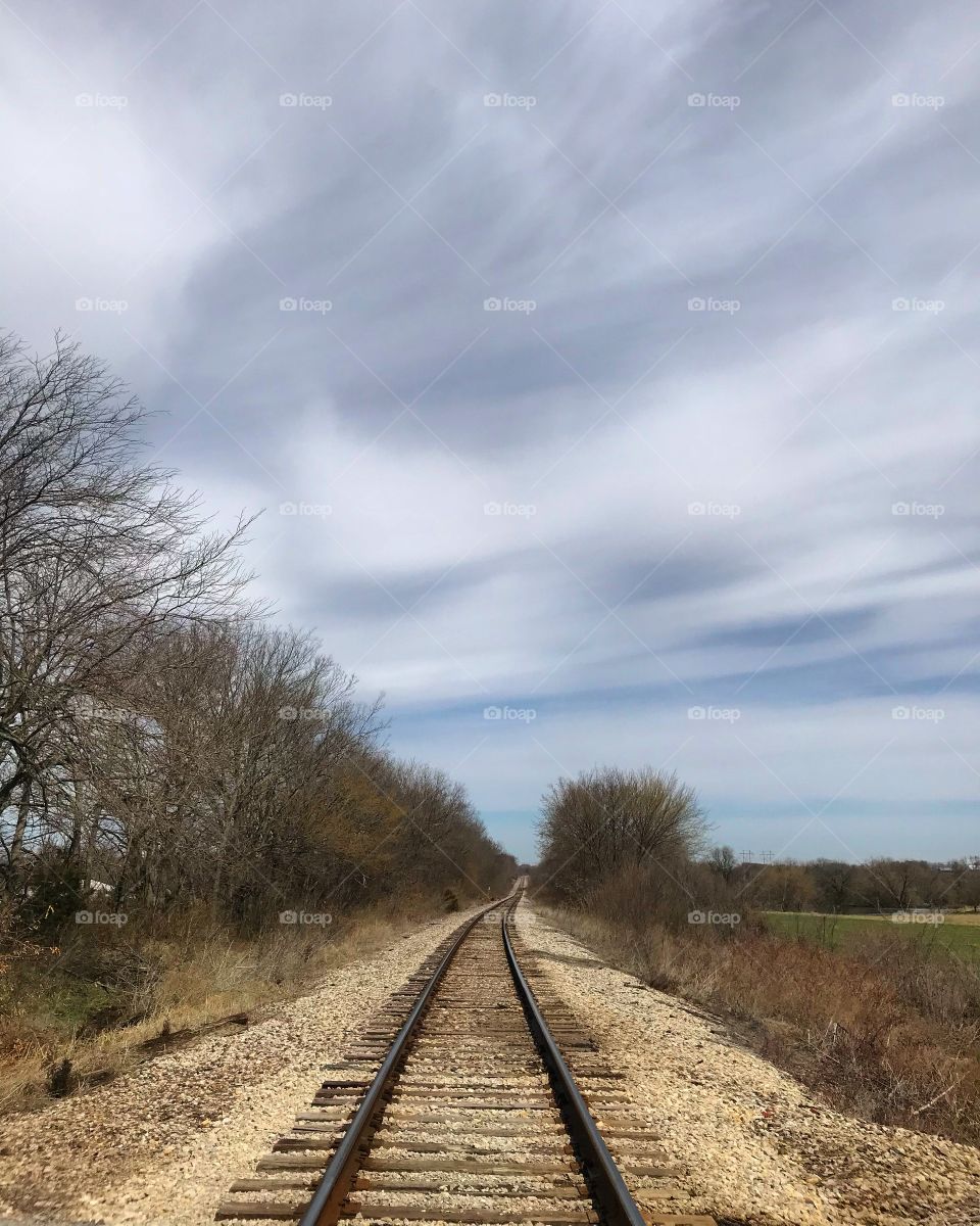 Cloudy shapes over the railroad tracks