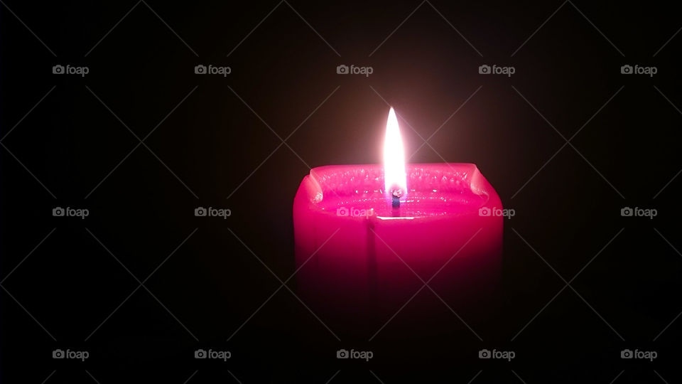 Close-up of illuminated red candle
