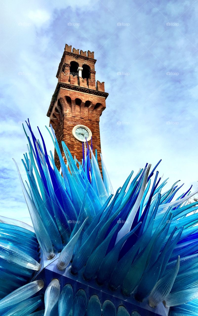 Murano Clock Tower. On a trip to Italy, I came across a clock tower on the island of Murano with an amazing glass sculpture in front of it. 