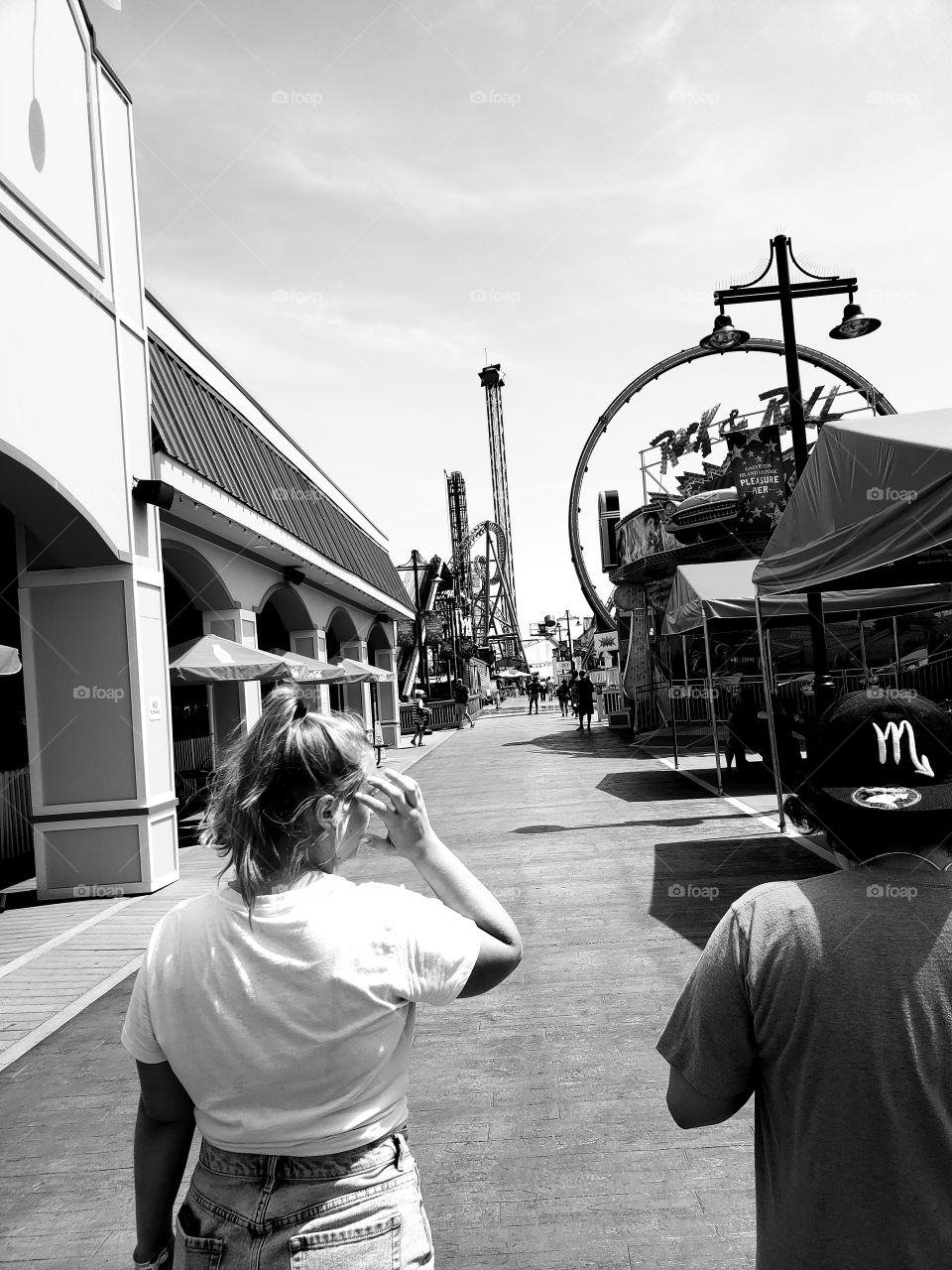 A monochrome filtered version of my fiance and sister walking down the beautiful Pleasure Pier at Galveston Beach.