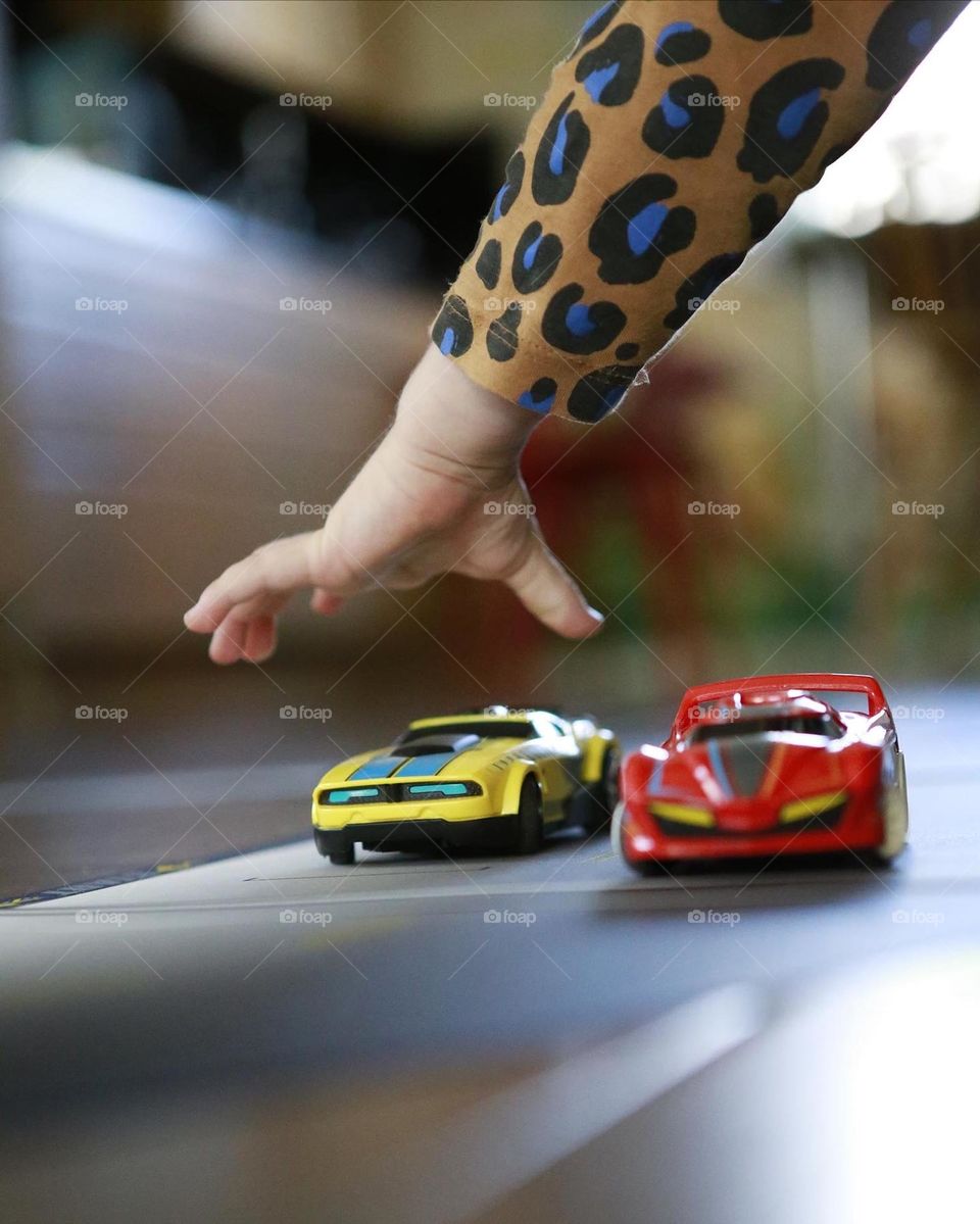 Child playing with model cars