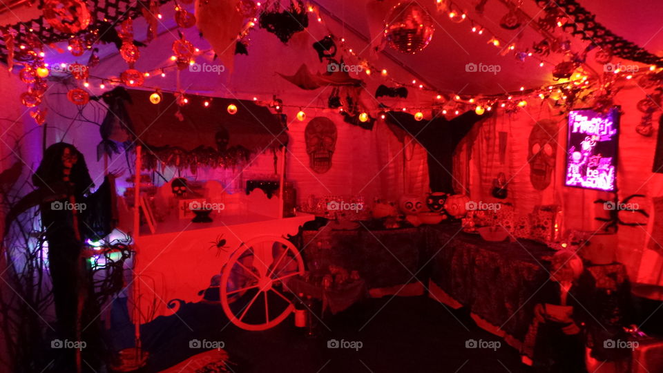 red lit Halloween  party with life sized figures and cart.