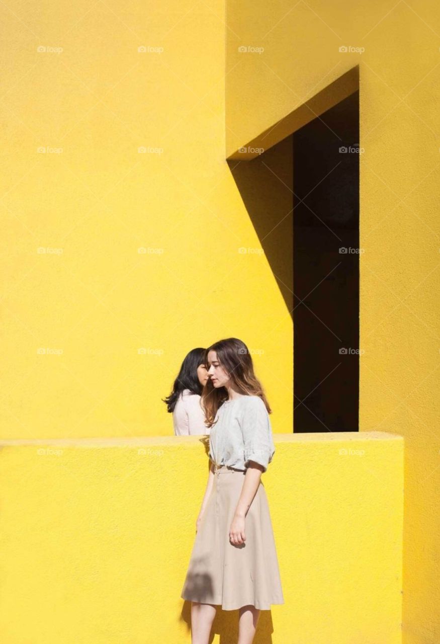 Girls walking architecture yellow bright 