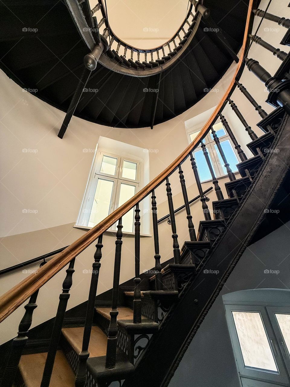Old spiral staircase in an old building in Poland, nice wooden stairs, big windows, unique forms